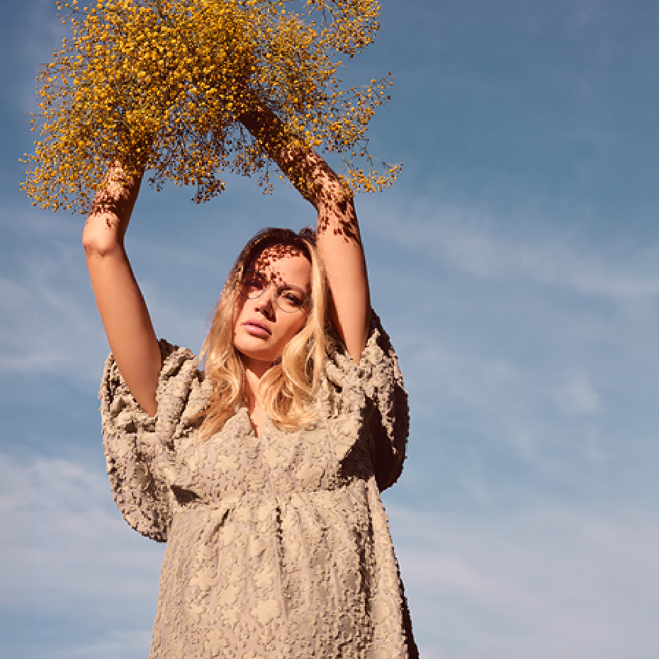 Brendel: Frau mit Brille hält Blumen